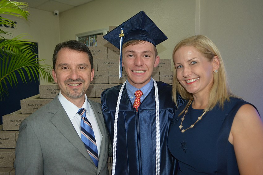 Richard and Amy Buck give their son, Patrick, a pre-ceremony hug. Patrick is headed to the University of Wisconsin to be a math major.