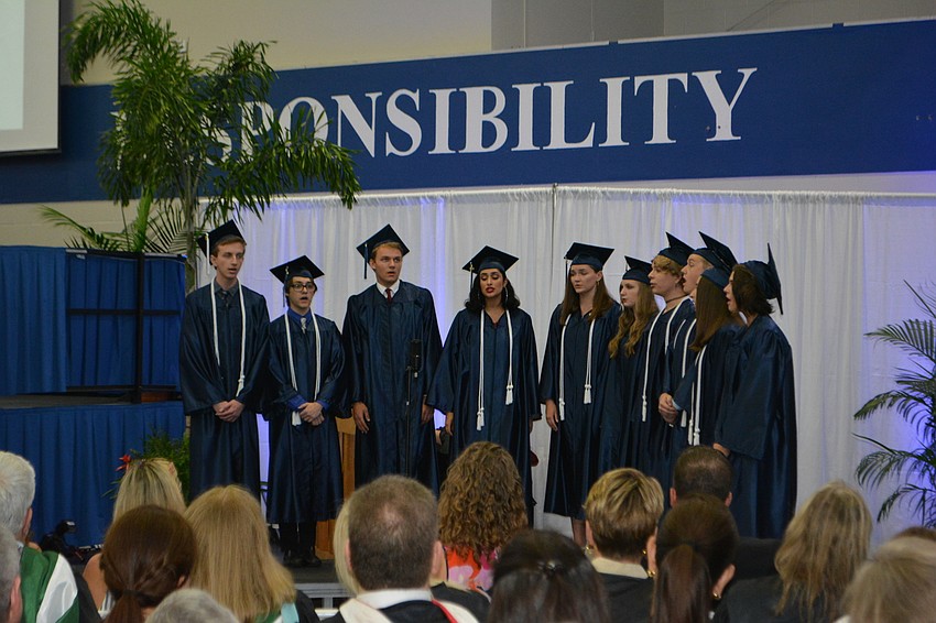 Senior chorus members deliver a musical presentation.