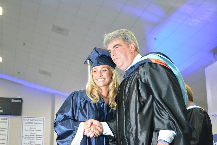 Hannah Bizick is congratulated by Head of School David Mahler.
