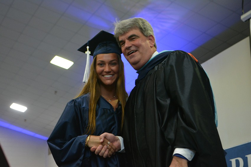 Seconds after Caroline Diesel is congratulated for graduating from Head of School David Mahler ...