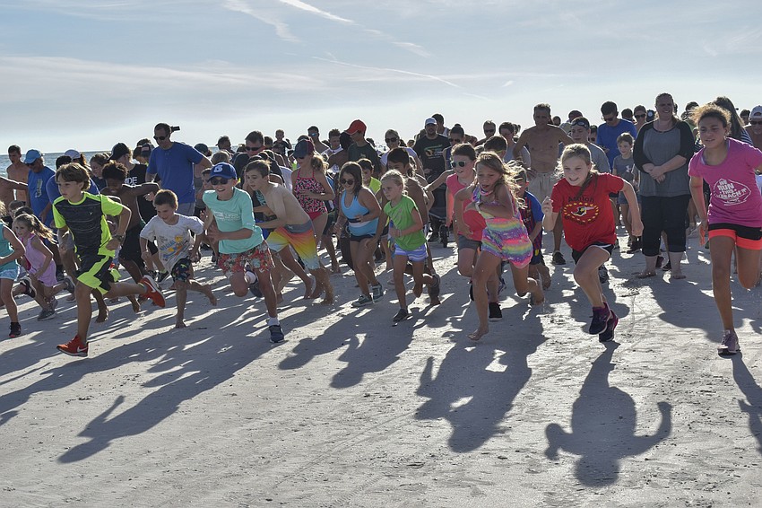 The young runners take off after hearing the airhorn go off.