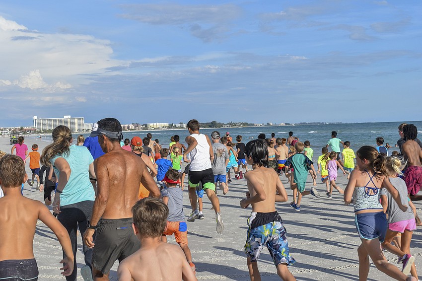 The runners start their mile-long run.