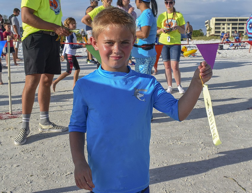 Brady Foster, 5, poses with his completion ribbon.