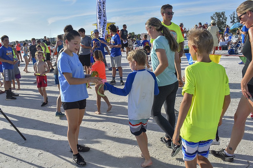 KC Wilburn passes out ribbons to participants.