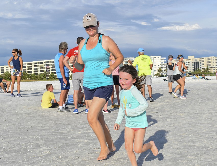 Jessie Batty (left) and daughter Josie Batty,4, complete their 1-mile run.