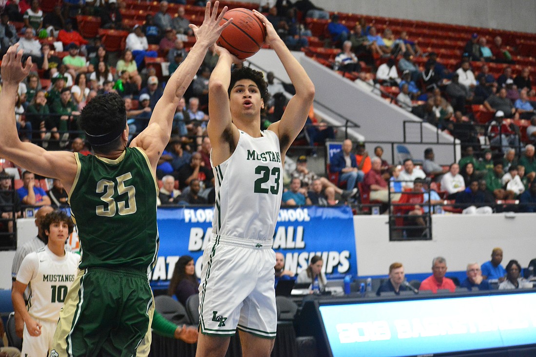 1. Lakewood Ranch junior Christian Shaneyfelt hits a 3-point shot over Gianfranco Grafals (35) against Fleming Island. Shaneyfelt finished with a game-high 21 points.