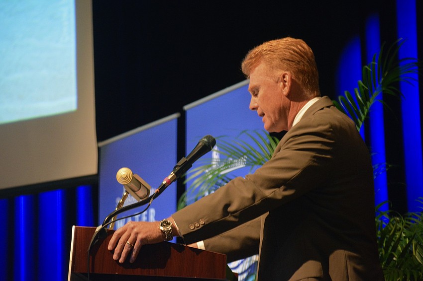 Commission Chair Charles Hines presents the panelists for the State Policy Update