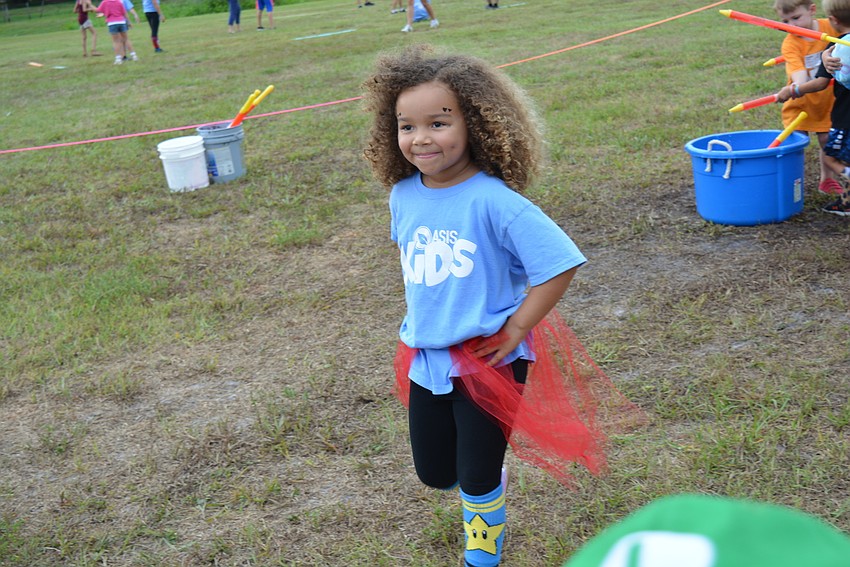 Gene Witt Elementary School student Hazel Fredericks, 5, completes the obstacle course with a grin. She also serves on the VBS worship team.