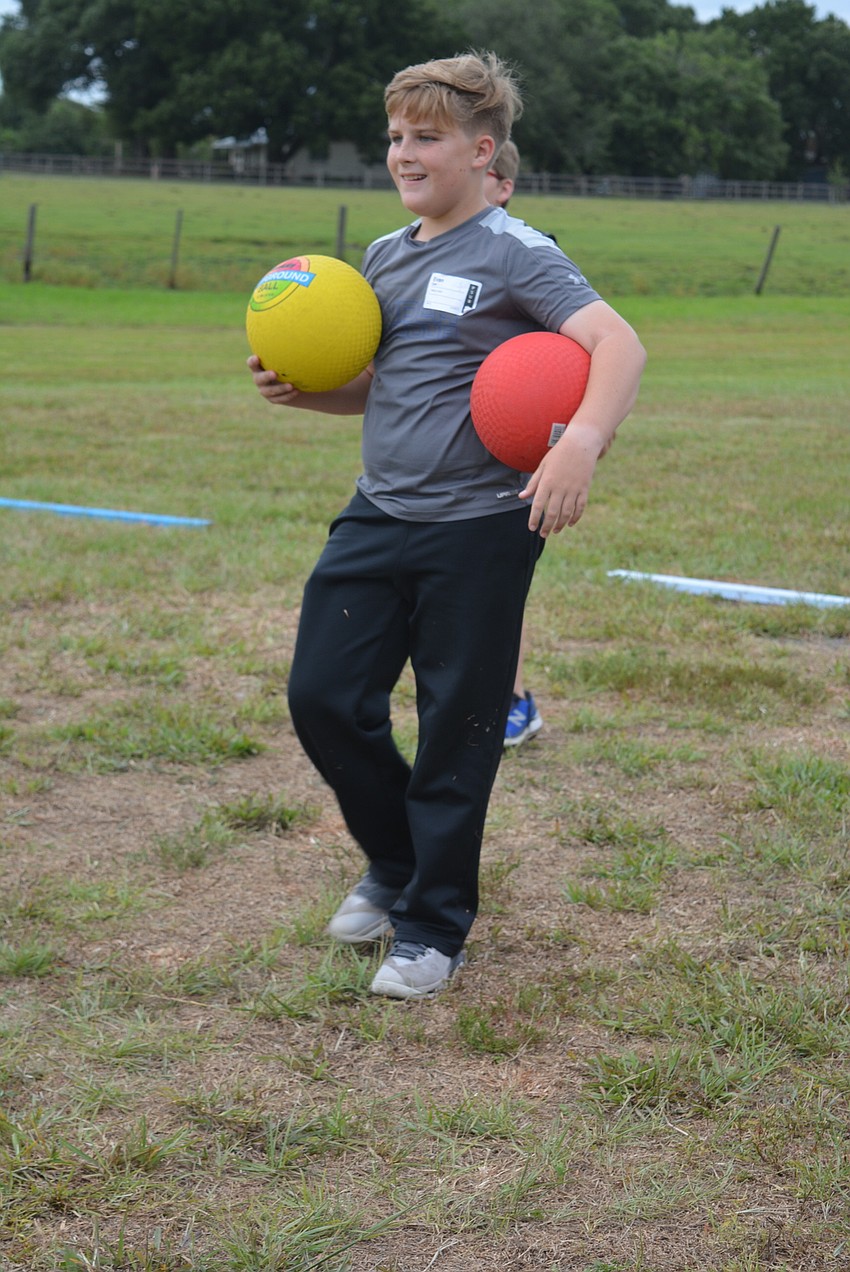 Ten-year-old Evan Carr hunts for the perfect opportunity to throw someone out while playing dodgeball.