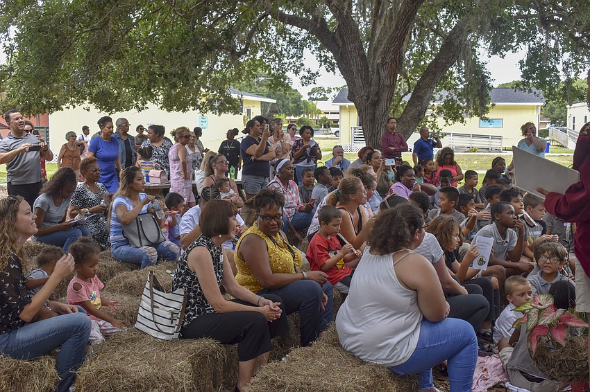 Teachers, family members and fellow students watch 