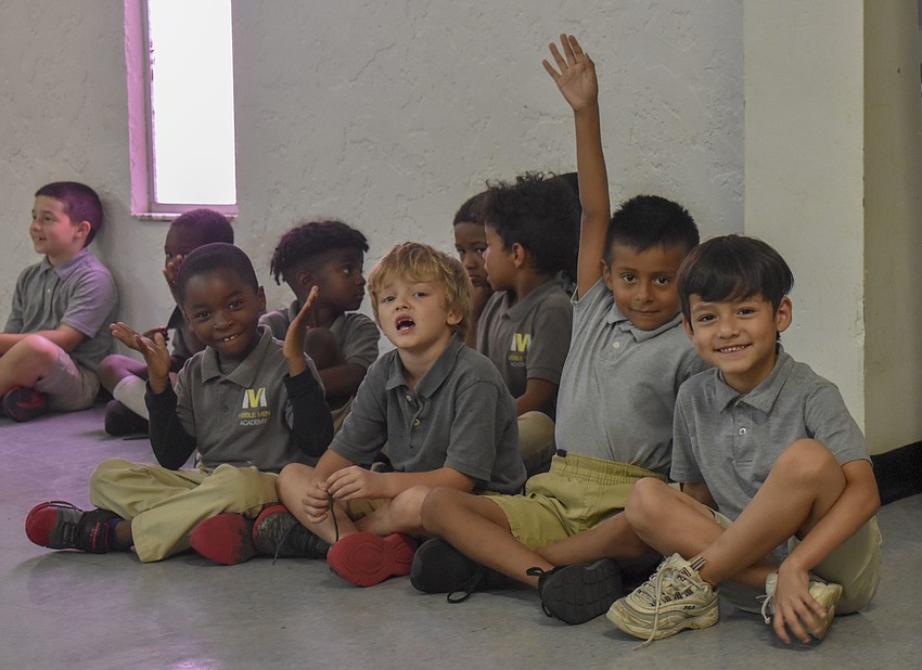 The kindergarten and first grade class wait for their turn to perform.