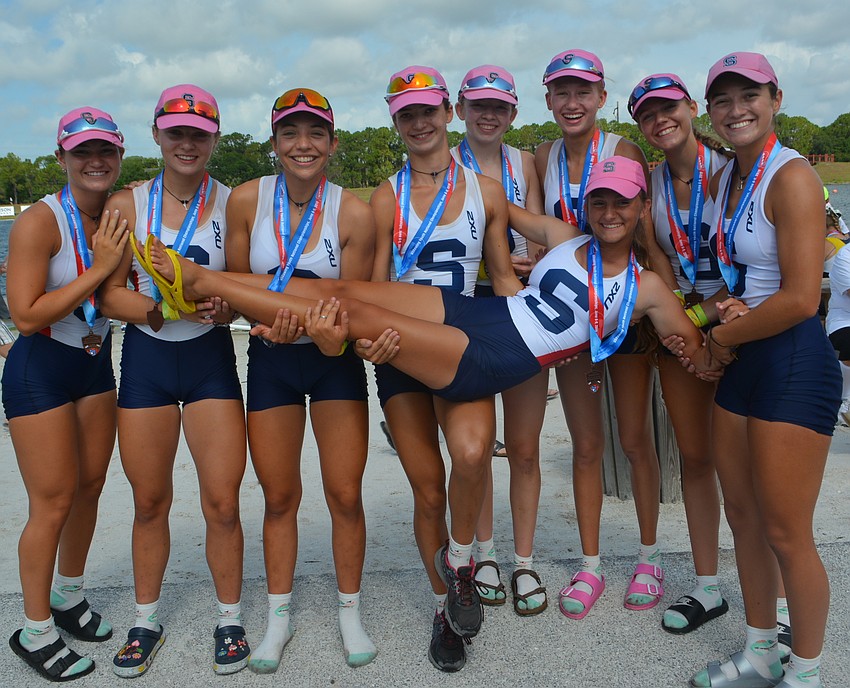 Sarasota Crew Women's Lightweight 8+ members Lucy LaCivita, Lizzie Jendrysik, Chyara Kruger, Eva Harris, Eiley Maginness, Cecelia Plass, Juliette Schumacher and Isabella Gomez and coxswain Graycen Arias (being held) celebrate.