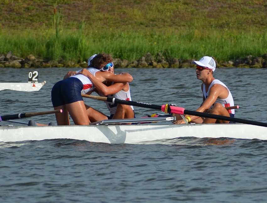 Sarasota Crew Men's 8+ Lightweight team members Logan Brown and William Young embrace after a second-place finish.