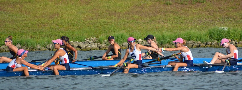 The Sarasota Crew Women's 8+ Lightweight team celebrates after a third-place finish.