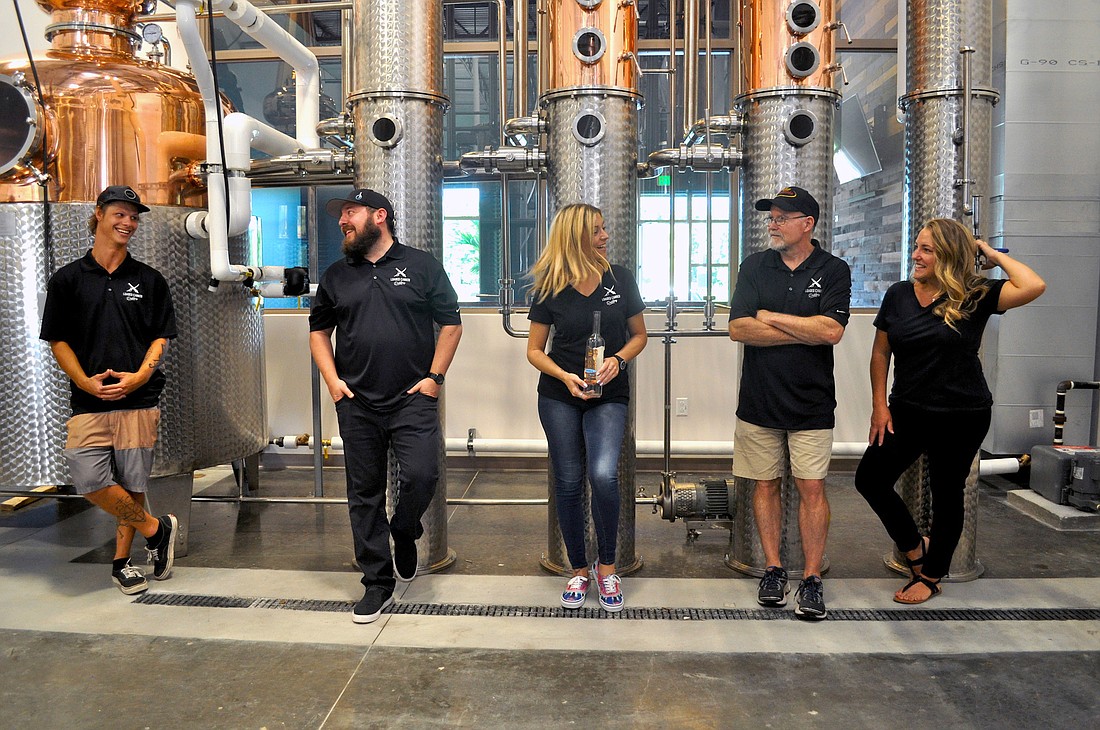 The Loaded Cannon team shows off their state-of-the art equipment. Dan Duvall, distiller, Justin Hertz, consulting partner, Michelle Russell, director of marketing, Steve Milligan, owner, and Lisa Lehnert, director of finance.