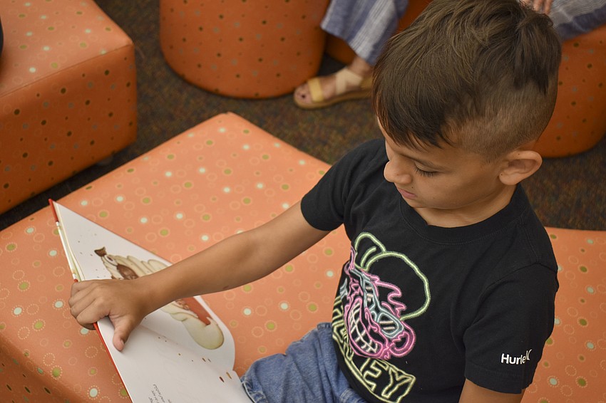 Kingston Willhen, 7, reads his new book out loud.