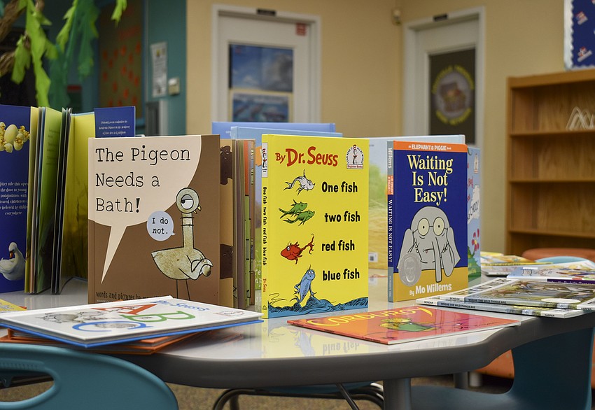 Children pick from books like 