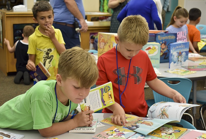 Miles Wilkes, 6, and Chase Lutz, 6, read their new books together.