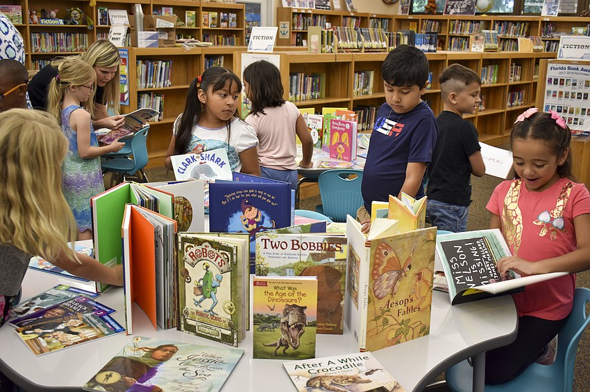 Fruitville Elementary School students look through the 250 books from the Jewish Family and Children’s Service of the Suncoast.