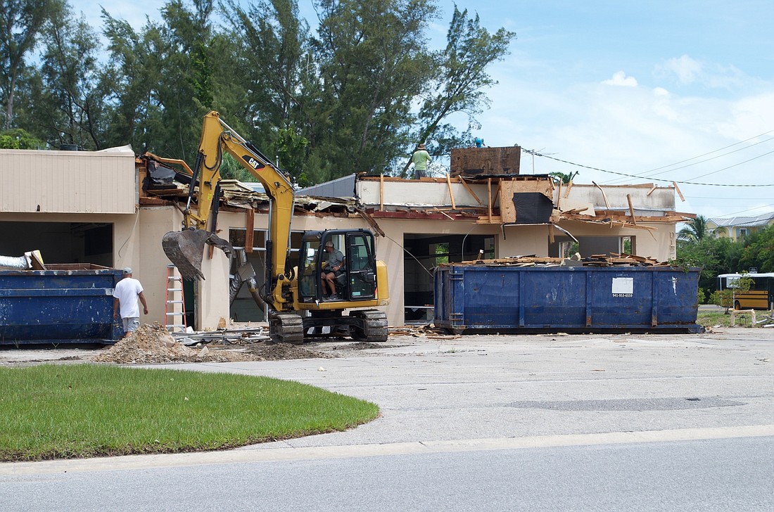 Workers began this week tearing down portions of the former gas station at Broadway Street and Gulf of Mexico Drive.