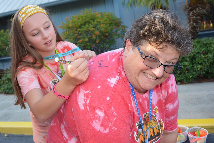 Lakewood Ranch 15-year-old Ellie Smyth signs the T-shirt of fellow counselor Carmen Raddatz. It's a tradition that started in 2018.