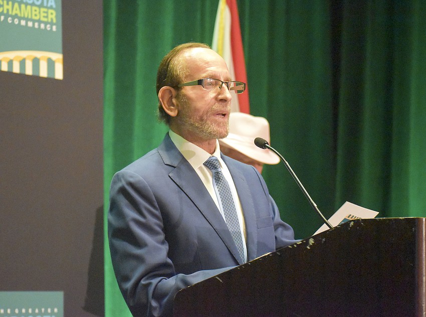 Peter Wish, chairman of Sarasota Manatee Airport Authority, presents the Hospitality and Tourism Organization of the Year.