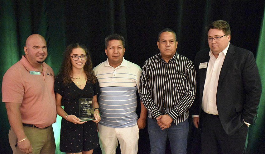 Sandy Rodriguez (left) owner of Unlimited Comfort Mattress Factory wins Retail Business of the Year.