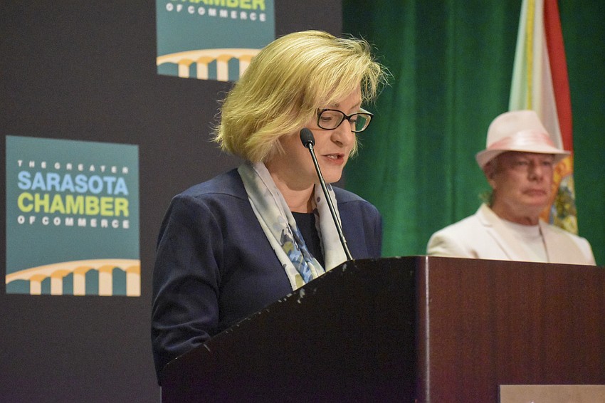 Beth Ebersole, shareholder of Kerkering Barberio Co., presents the award for Products and Services Business of the Year.