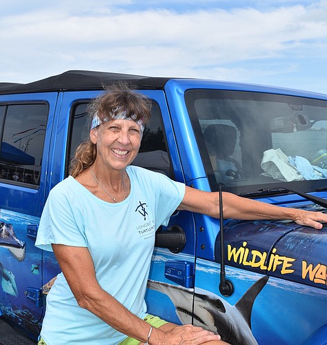 Charlene Donnelly said she purposely bought a used Jeep Wrangler in that blue color to blend with her custom artwork wrap.