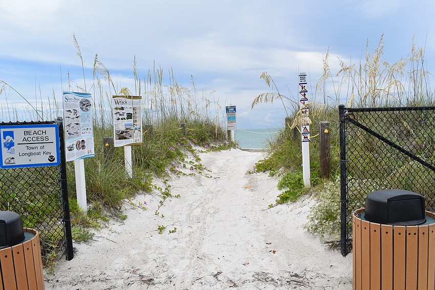Private property is nearby, so signs help direct visitors to the public beach.