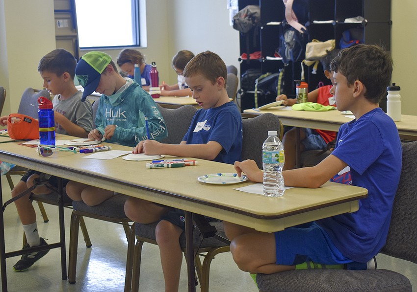 Hudson Ettinger, Beau  Viveley, Austin Taylor and Vukan Kovacevic plan out their coral drawings.