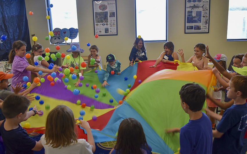 The Aqua Kids play a game that teaches them how a sedentary coral polyps gets its food.