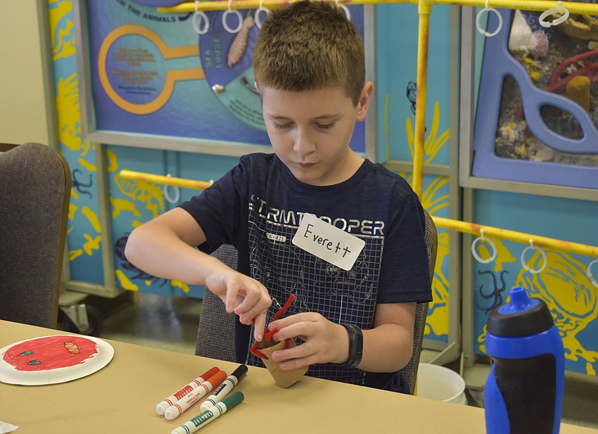 Everett McCollough adds pipe cleaners to his coral polyp.