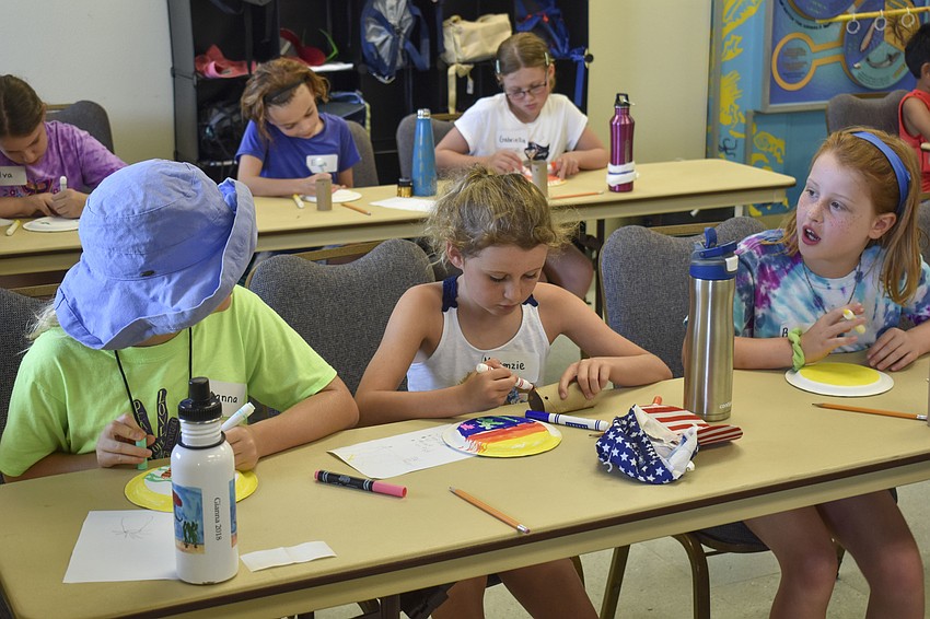 Gianna Freda, Mackenzie Ashburn and Beatrice Bradburn work intently on their coral polyps.