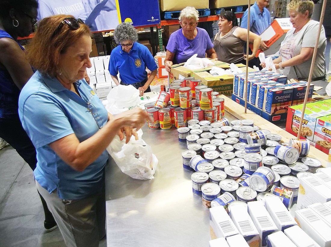 Rotary Club of Lakewood Ranch member Sybil Porter and eight fellow Rotarians bagged 5,184 meals for the Sack Summer Hunger program at The Food Bank of Manatee May 21. Courtesy photo.