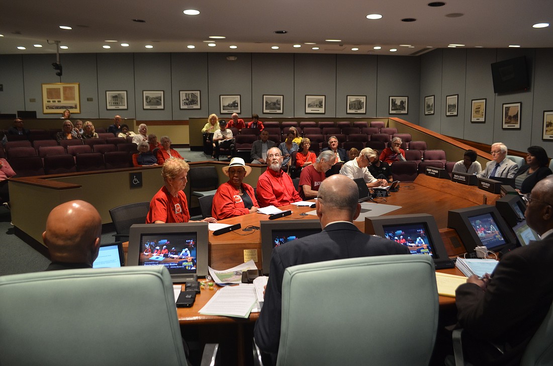 Supporters of the resident group STOP wore red to Monday&#39;s meeting as part of an effort to expand the use of public hearings to review development proposals. The commission ultimately kept all existing review procedures in place.