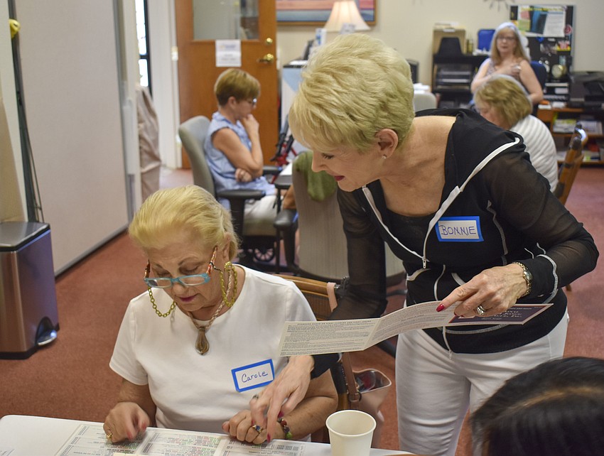 Volunteer coach Bonnie Wilder points out different combinations to Carole Shaw.