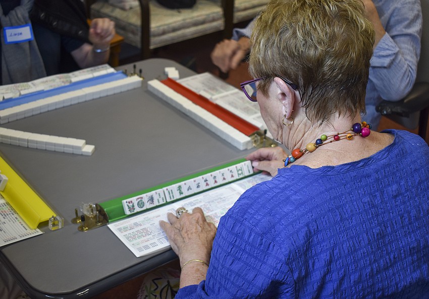 Mickey Sullivan looks over her new set of tiles.