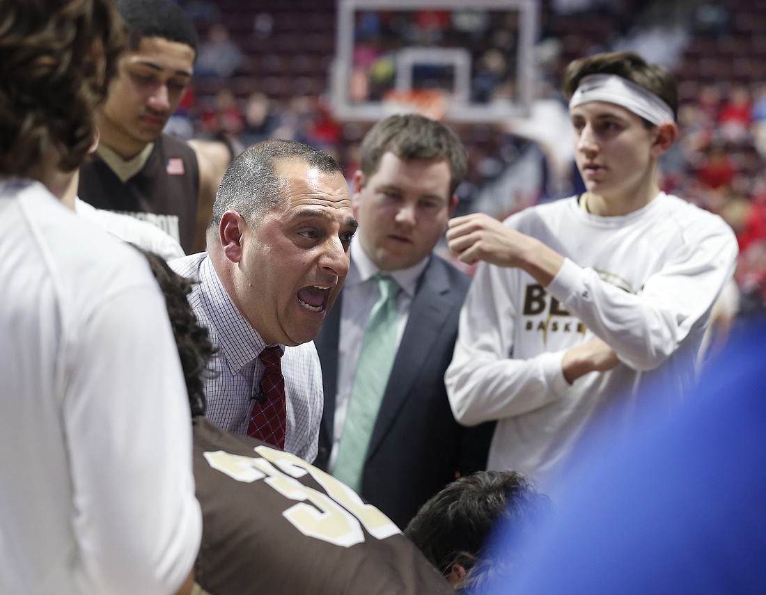 John Luzzi, pictured talking with his Stonington High team, is the new boys basketball coach at Cardinal Mooney High. Photo courtesy Tim Martin, The Westerly (R.I) Sun.