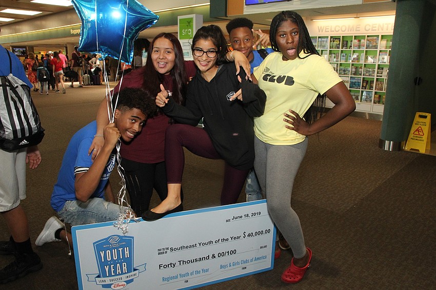 Bryan, Jasmine, Leonela Tase Sueiro, William and Tyanna show off with the $40,000 check.