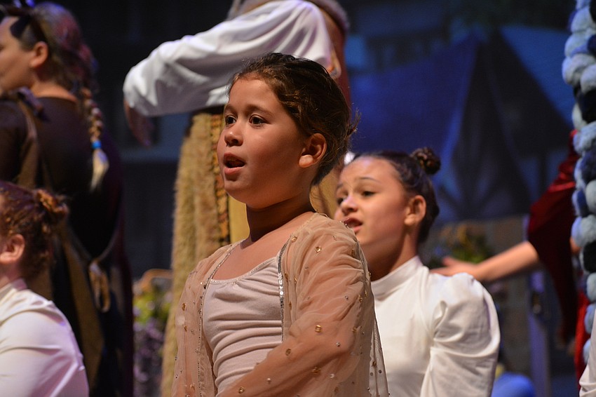 Aslyn McBride sings as part of the Snow Chorus.