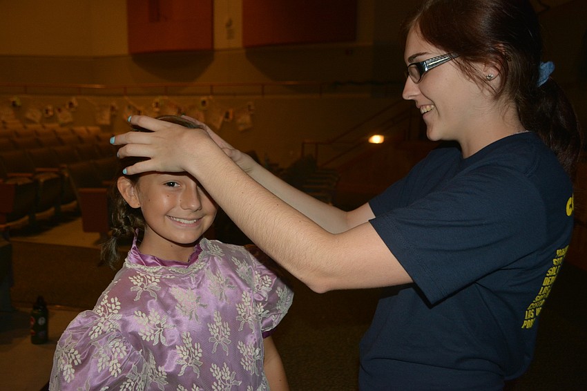Kemrie Henson, who plays Little Elsa, gets some last-minute help from Rachael Davis.