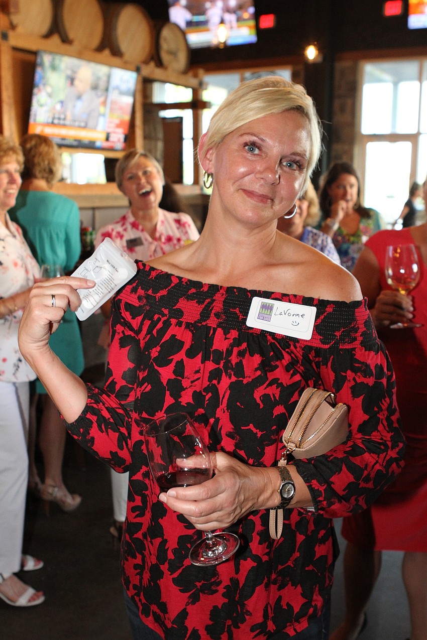 LaVonne Bower wins a miniature fan for her phone.