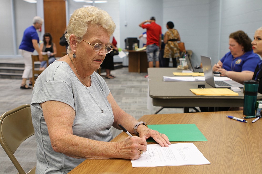 Mary Ann White fills out paperwork to be a bus aide. She says she is excited to work with children.