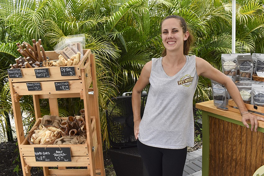 Jilian Alumbaugh, organizer of the event, shows off Pet Wants' dog treats.
