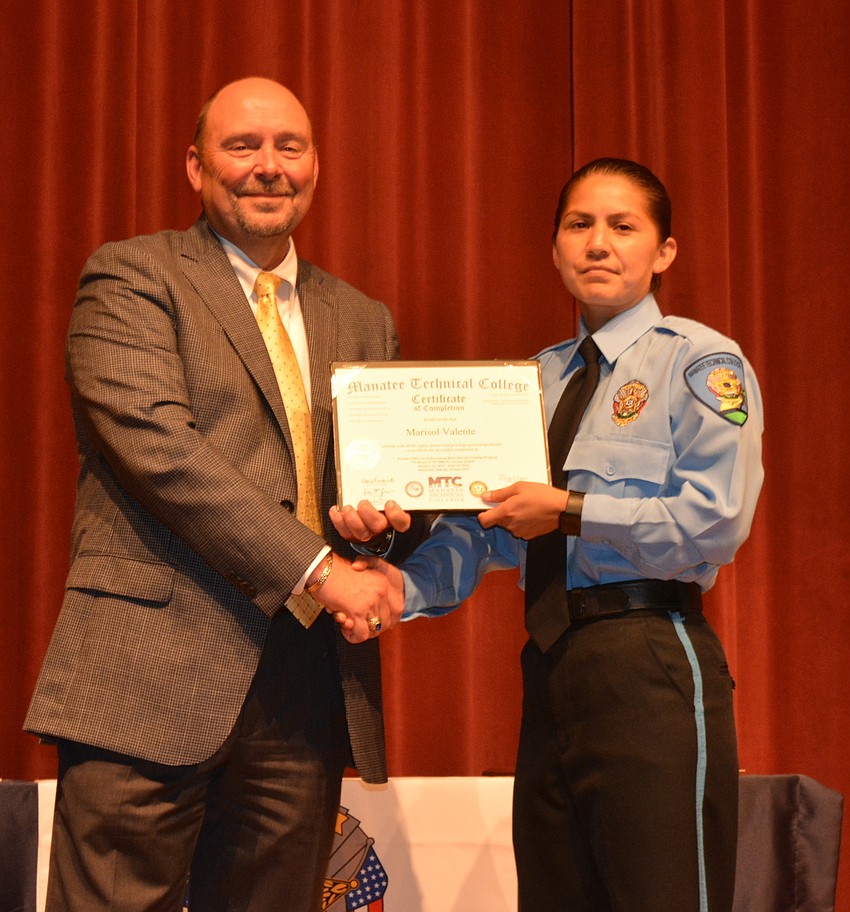 Marisol Valente receives her certificate for completing the Florida Law Enforcement Academy at Manatee Technical College.