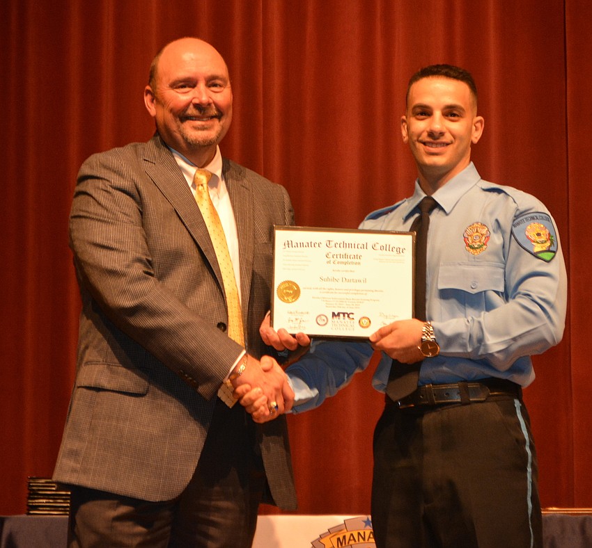 Suhibe Dartawil receives his certificate for completing the Florida Law Enforcement Academy at Manatee Technical College.
