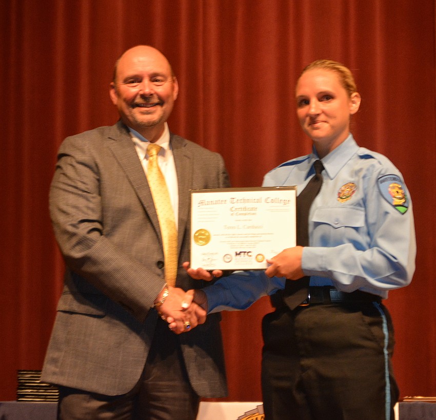 Teres Carducci receives her certificate for completing the Florida Law Enforcement Academy at Manatee Technical College.