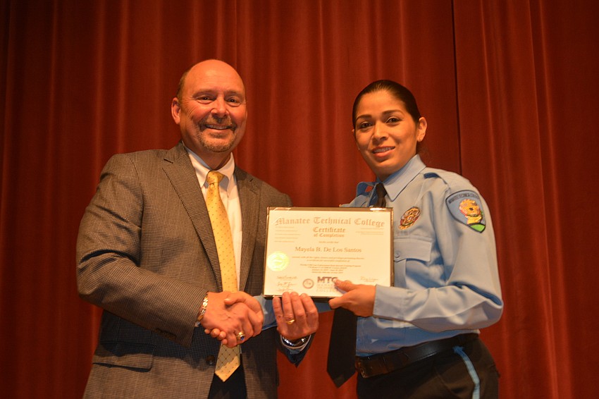 Mayela De Los Santos receives her certificate for completing the Florida Law Enforcement Academy at Manatee Technical College.