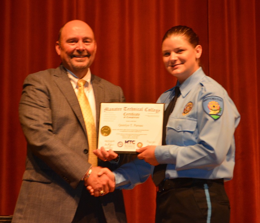 Quin Parnau receives her certificate for completing the Florida Law Enforcement Academy at Manatee Technical College.
